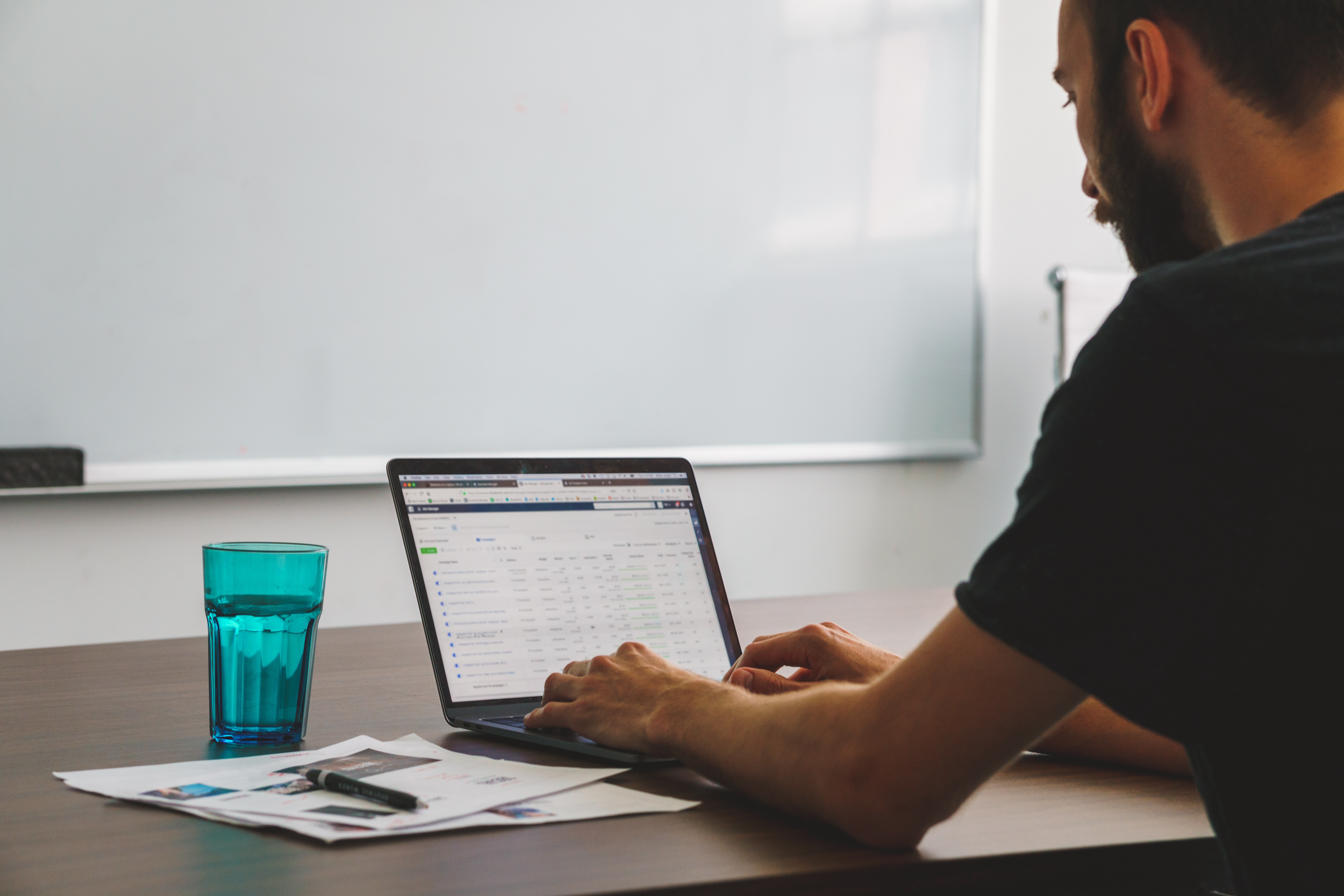 A curious businessman looking over the statistics in his self-serve advertising account.