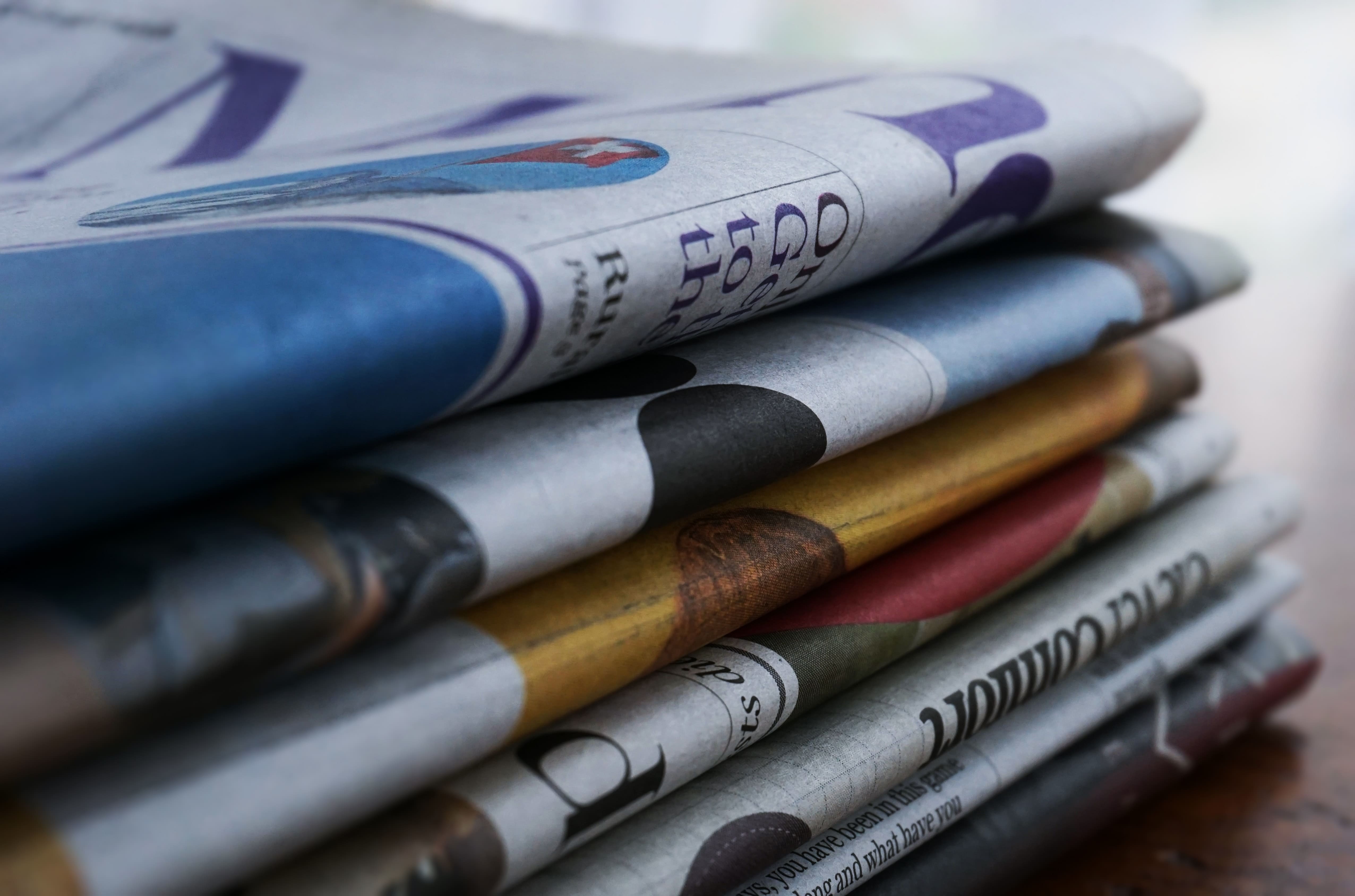 Pile of newspapers that have been published using advertisment management software 