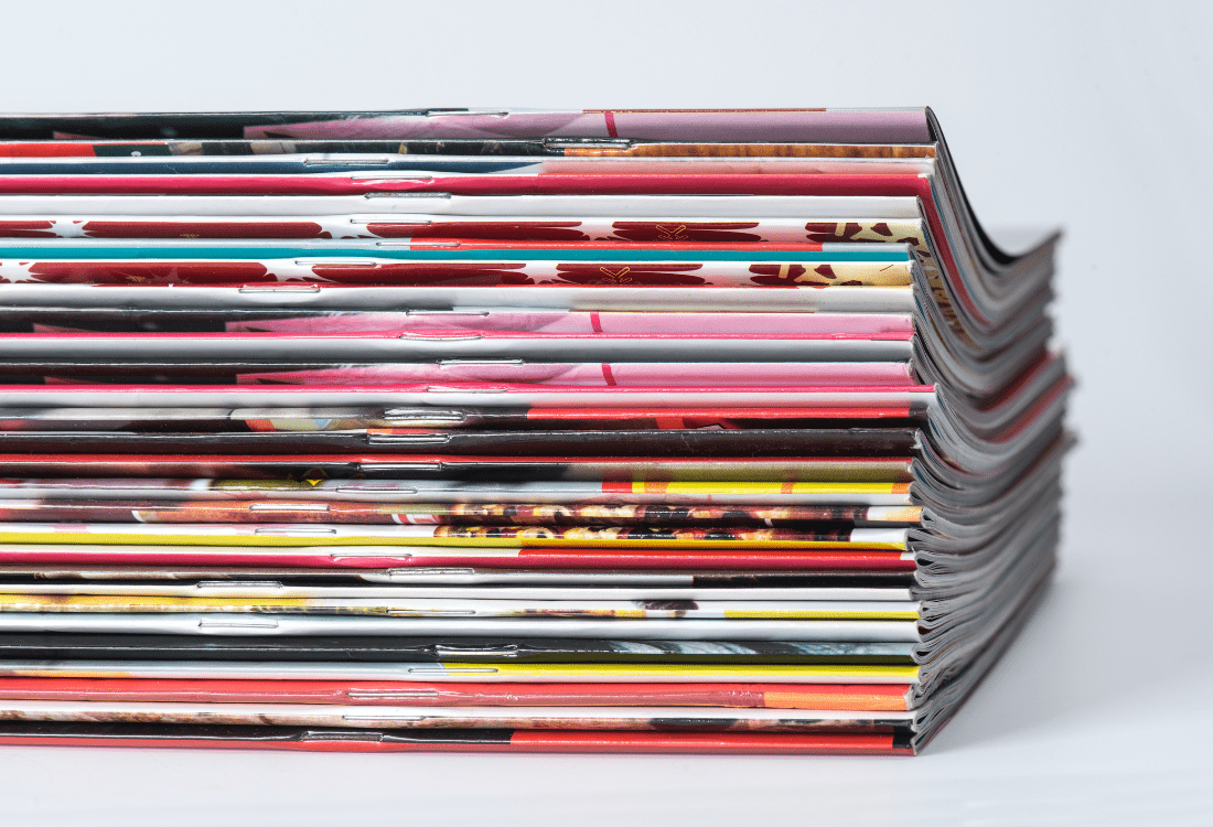 A stack of colourful magazines made by publishers that use digital workflow software to create the magazines. 